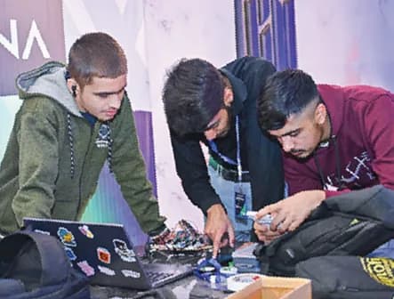 Students assembling electronics at a project stall