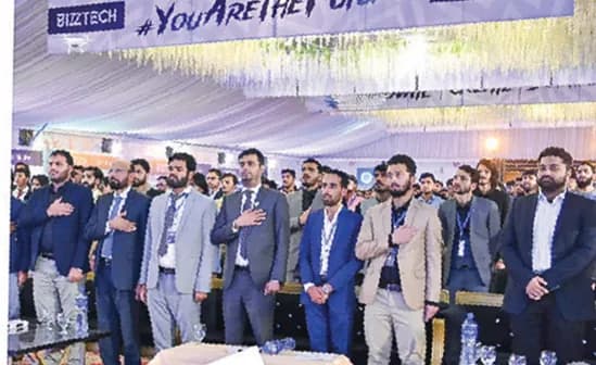 Guests standing for the national anthem at BizzTech