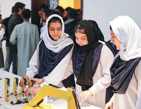 Students demonstrating a robotic arm